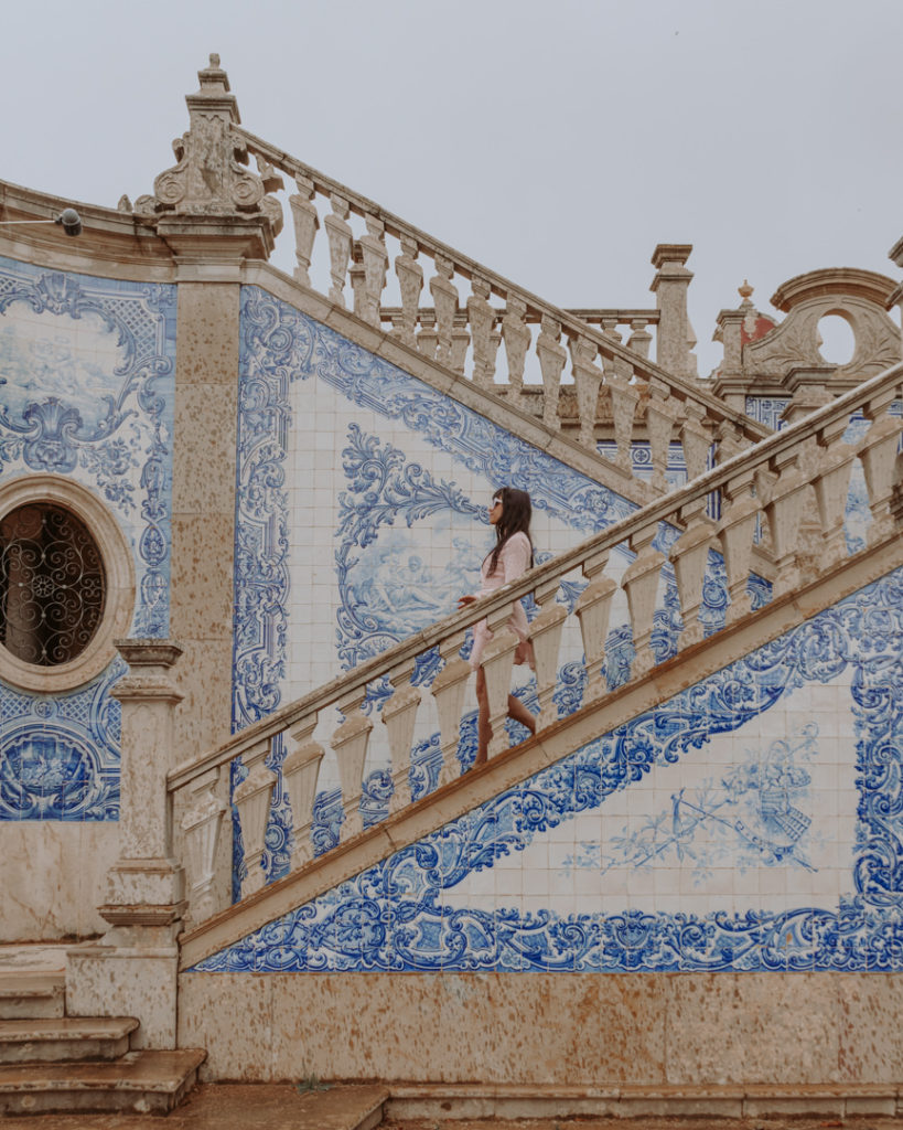 Woman walking down blue tiled staircase