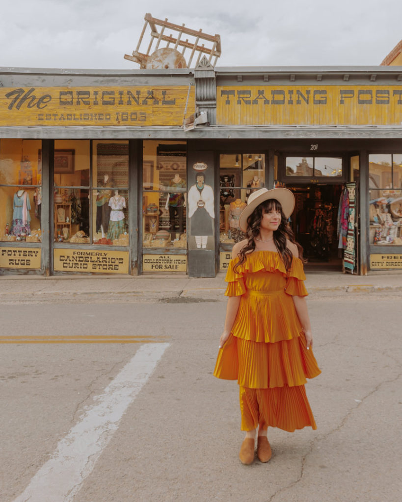 Woman in yellow dress in front of shop