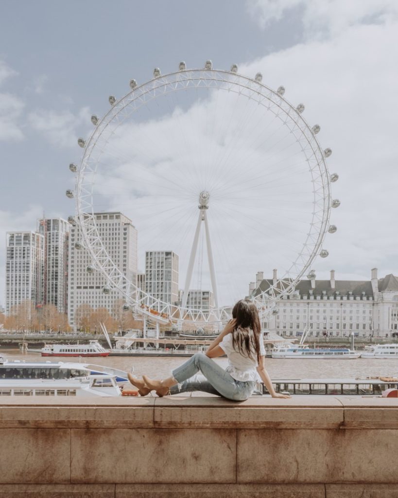 woman sitting in front of observation wheel