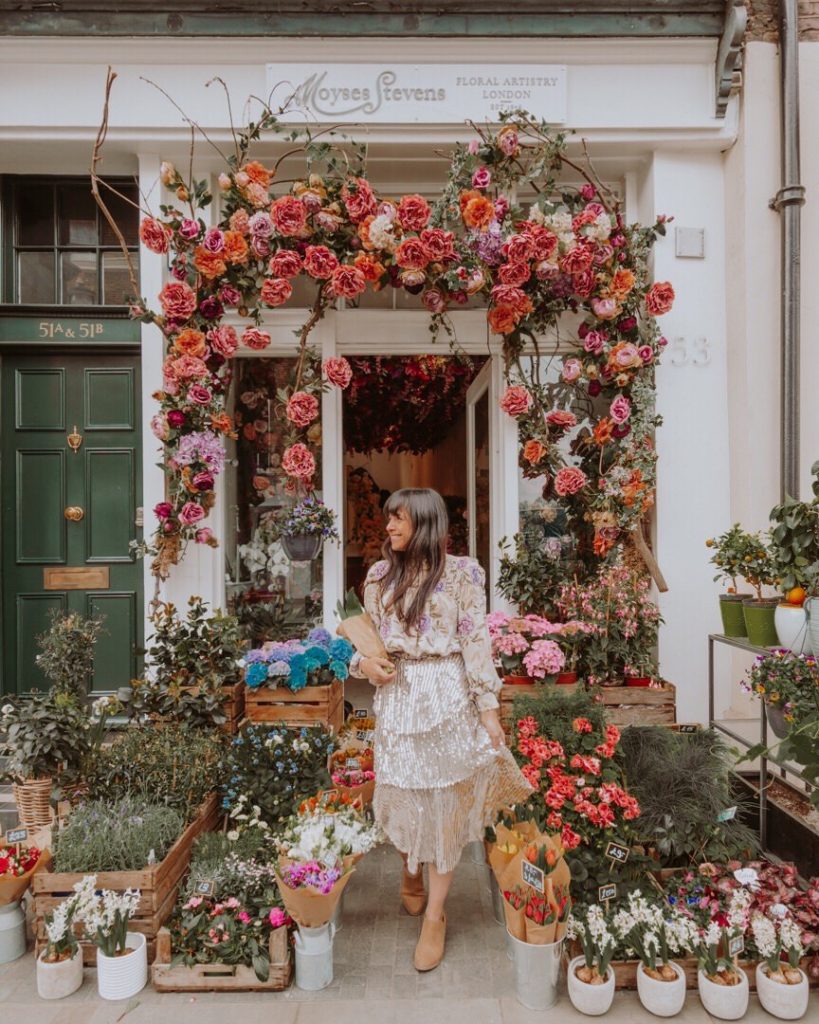 Woman standing outside of flower shop