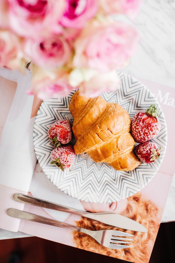 Plate with croissant and strawberries
