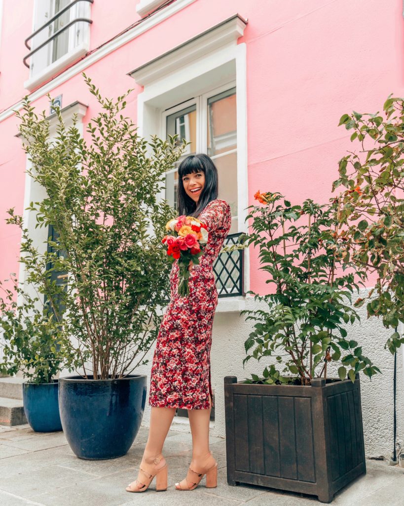 woman in dress holding flowers