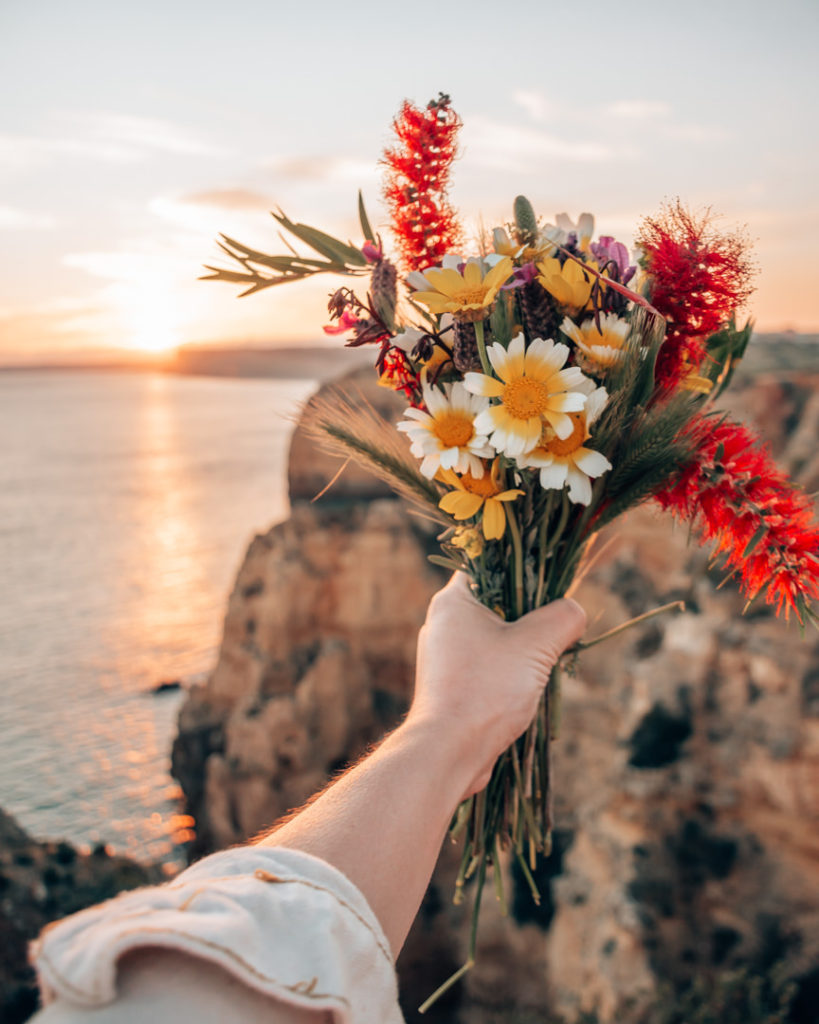 Woman's hand holding bouquet of flowers