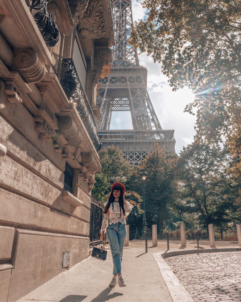 Woman walking in front of Eiffel Tower