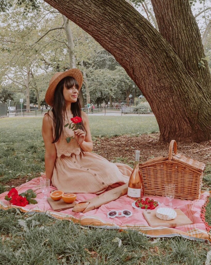 Woman holding a rose at a picnic