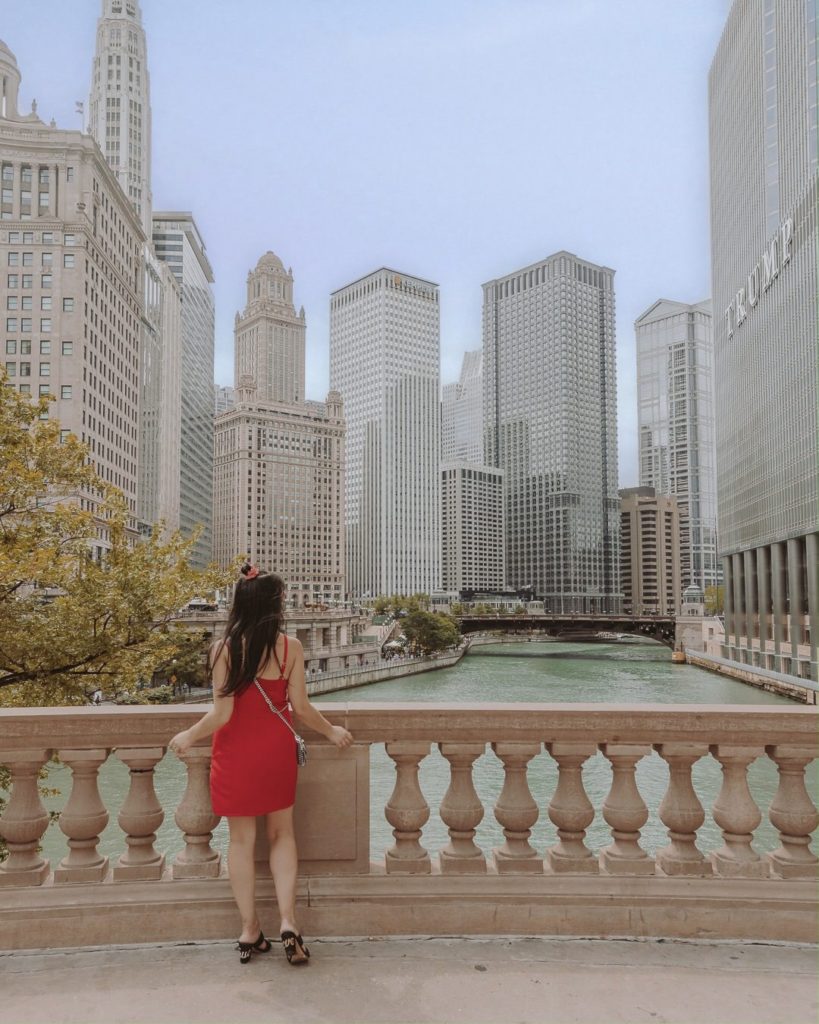 Woman in red dress standing looking at skyline