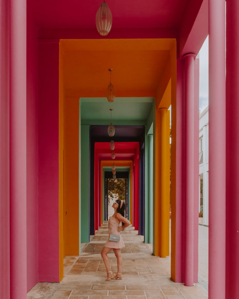 Woman standing under colorful arch