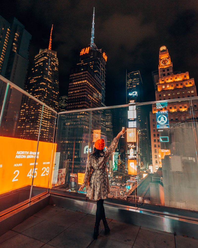Woman standing on balcony overlooking Times Square