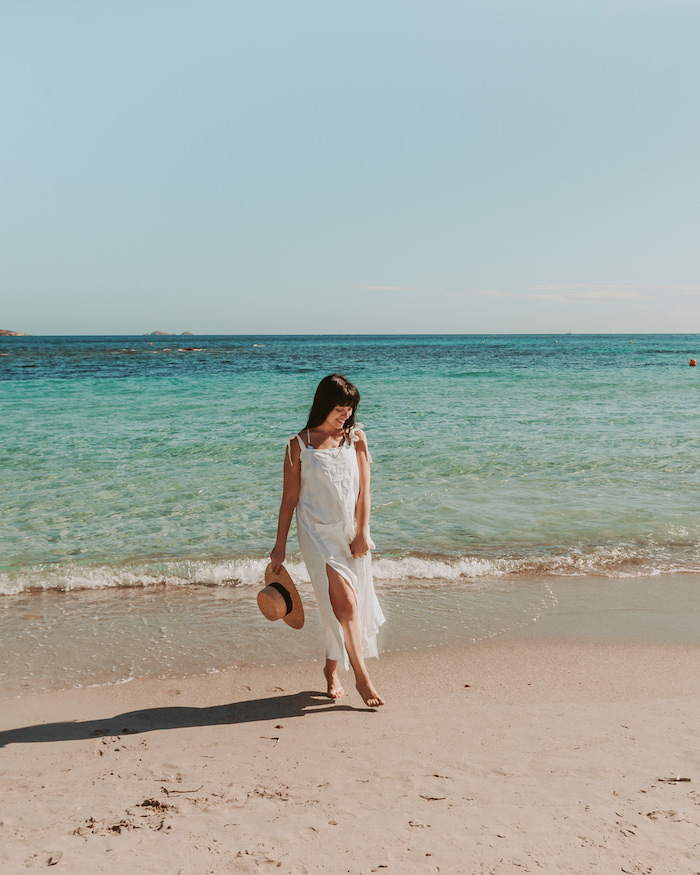 Woman in white dress walking on beach