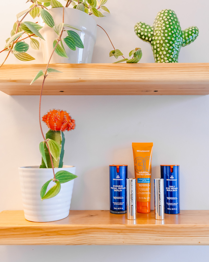 MDSolarSciences products in blue, orange and silver packaging displayed on a wooden bathroom shelf as part of a skincare routine in the winter