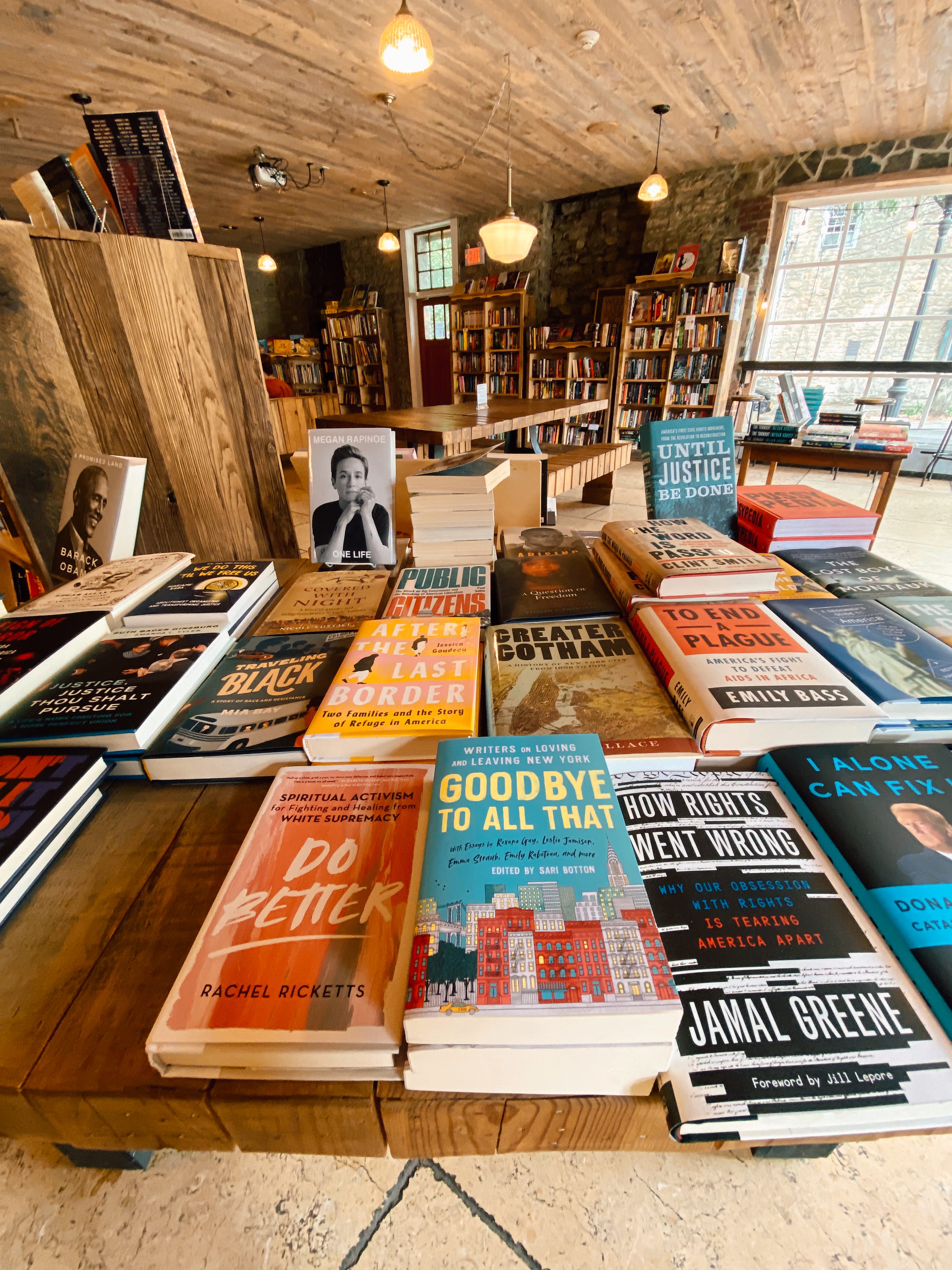 A table covered with books inside the bookstore Rough Draft Books, one of the best things to do in Kingston, NY